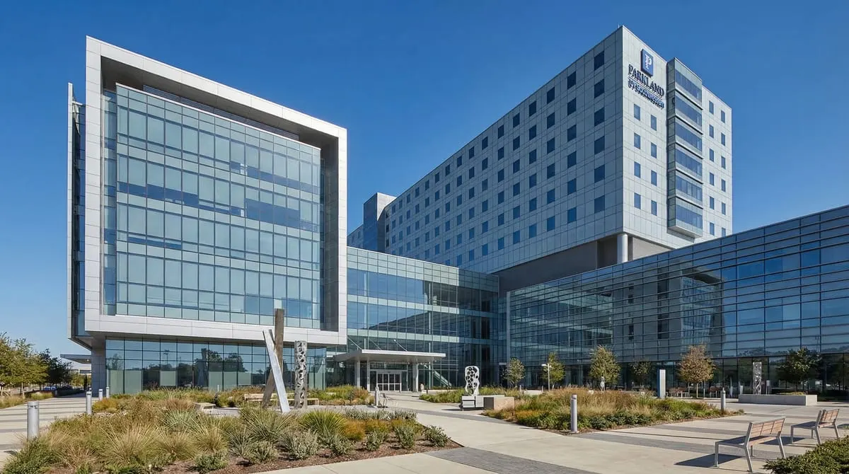 Parkland Memorial Hospital exterior in the Dallas Medical District, modern glass and steel trauma center building with landscaped plaza