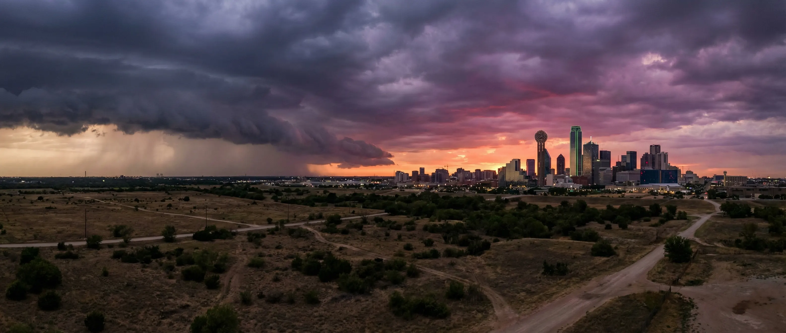 Dallas Texas skyline with dramatic storm clouds and sunset