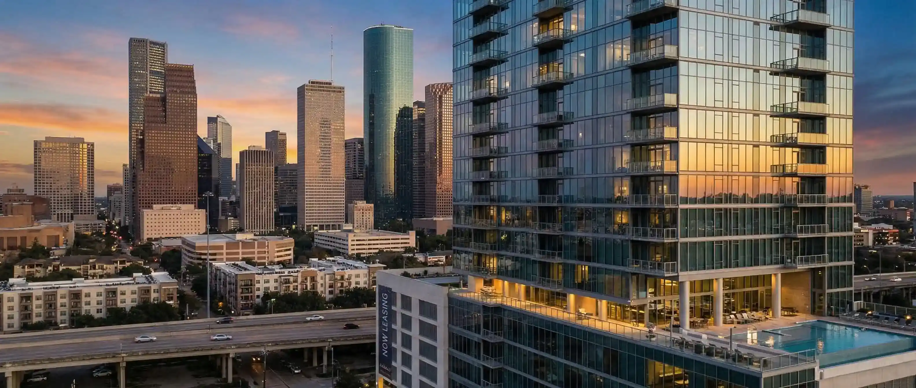 Houston apartment locator helping a client tour a luxury high-rise apartment with the Houston skyline visible through floor-to-ceiling windows