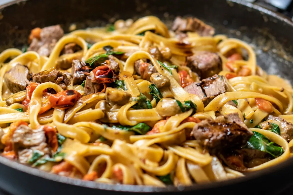 Fresh house-made pasta with sauce on an elegant plate