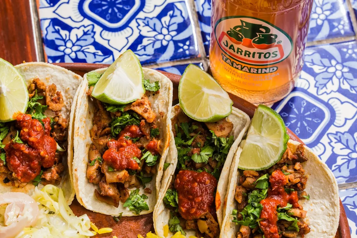 Sizzling fajitas on a cast iron plate with tortillas and sides