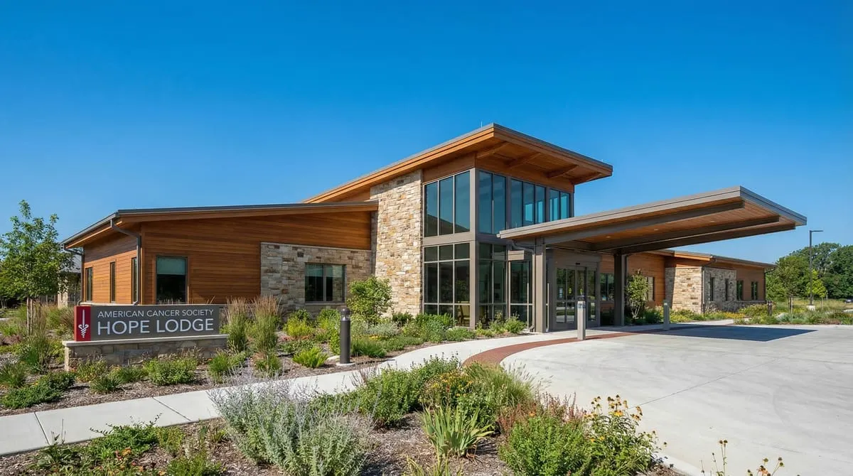 Exterior of an American Cancer Society Hope Lodge in Texas at dusk with landscaped gardens, Texas native plants, and warm light glowing from the windows